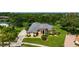 Aerial view of a beautiful home on a landscaped lot by a lake at 8312 Misty Lake Cir, Sarasota, FL 34241