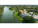 An aerial view of a waterfront home featuring a screened pool and beautiful landscaping at 8312 Misty Lake Cir, Sarasota, FL 34241