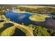 An aerial view of a community pond and golf course in a golf community at 8312 Misty Lake Cir, Sarasota, FL 34241