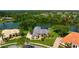 Aerial view of a house on a waterfront property surrounded by lush landscaping at 8312 Misty Lake Cir, Sarasota, FL 34241