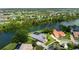 A beautiful waterfront neighborhood with luxurious homes and lush landscaping is captured in an aerial view at 8312 Misty Lake Cir, Sarasota, FL 34241