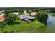 Aerial view of a beautiful home with a screened pool and view of the lake at 8312 Misty Lake Cir, Sarasota, FL 34241