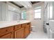 Bathroom featuring a solid-surface vanity, mirror, and tub/shower with white tile surround at 8312 Misty Lake Cir, Sarasota, FL 34241