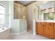 Well-lit bathroom with a separate shower, soaking tub, and ample counter space at 8312 Misty Lake Cir, Sarasota, FL 34241