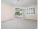A sunlit bedroom has a view of the swimming pool at 8312 Misty Lake Cir, Sarasota, FL 34241