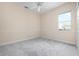 A sunlit bedroom boasts soft gray carpets and a window with outside views at 8312 Misty Lake Cir, Sarasota, FL 34241