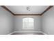 Cozy bedroom featuring a ceiling fan, large window, and neutral walls at 8312 Misty Lake Cir, Sarasota, FL 34241