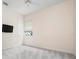 Bedroom featuring gray carpets, neutral walls, a ceiling fan, a tv, and a window at 8312 Misty Lake Cir, Sarasota, FL 34241