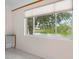 Bonus room featuring a large window overlooking a pond and wooded area, tile floors, and built-in wooden cabinets at 8312 Misty Lake Cir, Sarasota, FL 34241