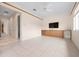 Open bonus room featuring tile floors, wooden trim and cabinets, a ceiling fan, recessed lights, and a TV at 8312 Misty Lake Cir, Sarasota, FL 34241
