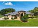 Stunning single story home with well manicured lawn, lush landscaping, and charming covered front porch at 8312 Misty Lake Cir, Sarasota, FL 34241