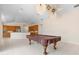 Game room featuring tile floors and access to the kitchen with stainless steel appliances and wooden cabinets at 8312 Misty Lake Cir, Sarasota, FL 34241