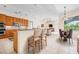 Open kitchen with counter seating, seamlessly connected to living and dining areas at 8312 Misty Lake Cir, Sarasota, FL 34241