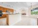 Spacious kitchen featuring a large island, tile floors, stainless steel appliances, and an adjacent sitting area at 8312 Misty Lake Cir, Sarasota, FL 34241