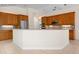 Spacious kitchen with light oak cabinets, stainless steel appliances and large island, perfect for entertaining at 8312 Misty Lake Cir, Sarasota, FL 34241