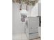 Well-lit laundry room with stacked washer/dryer and ample storage at 8312 Misty Lake Cir, Sarasota, FL 34241