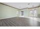 Elegant living room featuring gray wood flooring, stained glass double door entry, and hallway access at 8312 Misty Lake Cir, Sarasota, FL 34241
