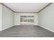 Spacious living room featuring sliding glass doors to a pool area and modern gray wood-look flooring at 8312 Misty Lake Cir, Sarasota, FL 34241