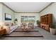 Bright living room with comfortable seating, stylish decor, and a view of the outdoor pool at 8312 Misty Lake Cir, Sarasota, FL 34241