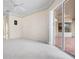 Covered patio area with tile flooring and a fan overlooking the backyard at 8312 Misty Lake Cir, Sarasota, FL 34241