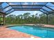 Screened in pool and jacuzzi overlook a scenic lake at 8312 Misty Lake Cir, Sarasota, FL 34241