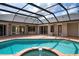 Screened in pool and spa, with a large brick paver patio at 8312 Misty Lake Cir, Sarasota, FL 34241
