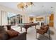 Large recreation room with a pool table, comfortable seating, and access to outdoor space at 8312 Misty Lake Cir, Sarasota, FL 34241