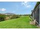 Lush backyard view with serene fountain and community landscaping beyond the yard at 8557 Milestone Dr, Sarasota, FL 34238