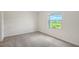Comfortable bedroom with plush carpeting and a view overlooking a green space at 8557 Milestone Dr, Sarasota, FL 34238