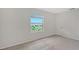 Bright bedroom with neutral carpet and a window view of the neighboring home at 8557 Milestone Dr, Sarasota, FL 34238