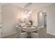 Elegant dining room with a modern chandelier and seating for four, perfect for intimate gatherings at 8557 Milestone Dr, Sarasota, FL 34238