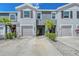 Inviting townhome exterior featuring well-maintained landscaping and attached garages at 8557 Milestone Dr, Sarasota, FL 34238