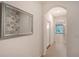 Bright hallway features tiled floors, an arched entryway, and a decorative mirror at 8557 Milestone Dr, Sarasota, FL 34238