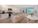 Modern kitchen with granite countertops, stainless steel appliances, and an open layout into the living area at 8557 Milestone Dr, Sarasota, FL 34238