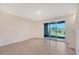 Open-concept living area with a sliding glass door and tile flooring at 8557 Milestone Dr, Sarasota, FL 34238
