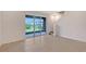 Cozy living area with tiled flooring, glass patio doors and stairs to the upper level at 8557 Milestone Dr, Sarasota, FL 34238