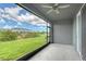 Outdoor screened patio provides views of the backyard and community green space at 8557 Milestone Dr, Sarasota, FL 34238