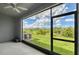Screened patio with ceiling fan overlooking serene backyard and lush green space at 8557 Milestone Dr, Sarasota, FL 34238
