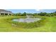 Scenic community pond featuring a fountain, surrounded by natural vegetation at 8557 Milestone Dr, Sarasota, FL 34238