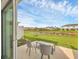 Outdoor back patio featuring outdoor seating and a view of the pond at 8733 Winter Breeze Way, Sarasota, FL 34241