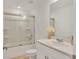 Bathroom with a shower and tub, white cabinets, and white countertops at 8733 Winter Breeze Way, Sarasota, FL 34241
