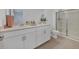 Bathroom with dual sinks, quartz counters, and glass-enclosed shower at 8733 Winter Breeze Way, Sarasota, FL 34241