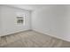 Bedroom with neutral carpet, bright natural light from the window, and neutral paint at 8733 Winter Breeze Way, Sarasota, FL 34241