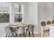 Cozy dining area with modern table set next to large windows for natural light at 8733 Winter Breeze Way, Sarasota, FL 34241
