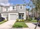 Charming two-story home featuring a one car garage, nicely landscaped front yard and a welcoming blue front door at 8733 Winter Breeze Way, Sarasota, FL 34241