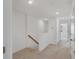 Upstairs hallway features wood railing and neutral carpeting at 8733 Winter Breeze Way, Sarasota, FL 34241