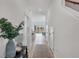 Hallway leads to an open kitchen with bar seating with an outside view and natural light at 8733 Winter Breeze Way, Sarasota, FL 34241