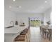 Open concept kitchen with island bar seating, a modern sink, view of the dining area, and a sliding glass door at 8733 Winter Breeze Way, Sarasota, FL 34241