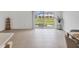 Bright living room with tile floors and sliding glass doors to the outdoor patio at 8733 Winter Breeze Way, Sarasota, FL 34241