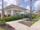 Pool clubhouse with outdoor seating, tropical landscaping, and covered area at 8733 Winter Breeze Way, Sarasota, FL 34241